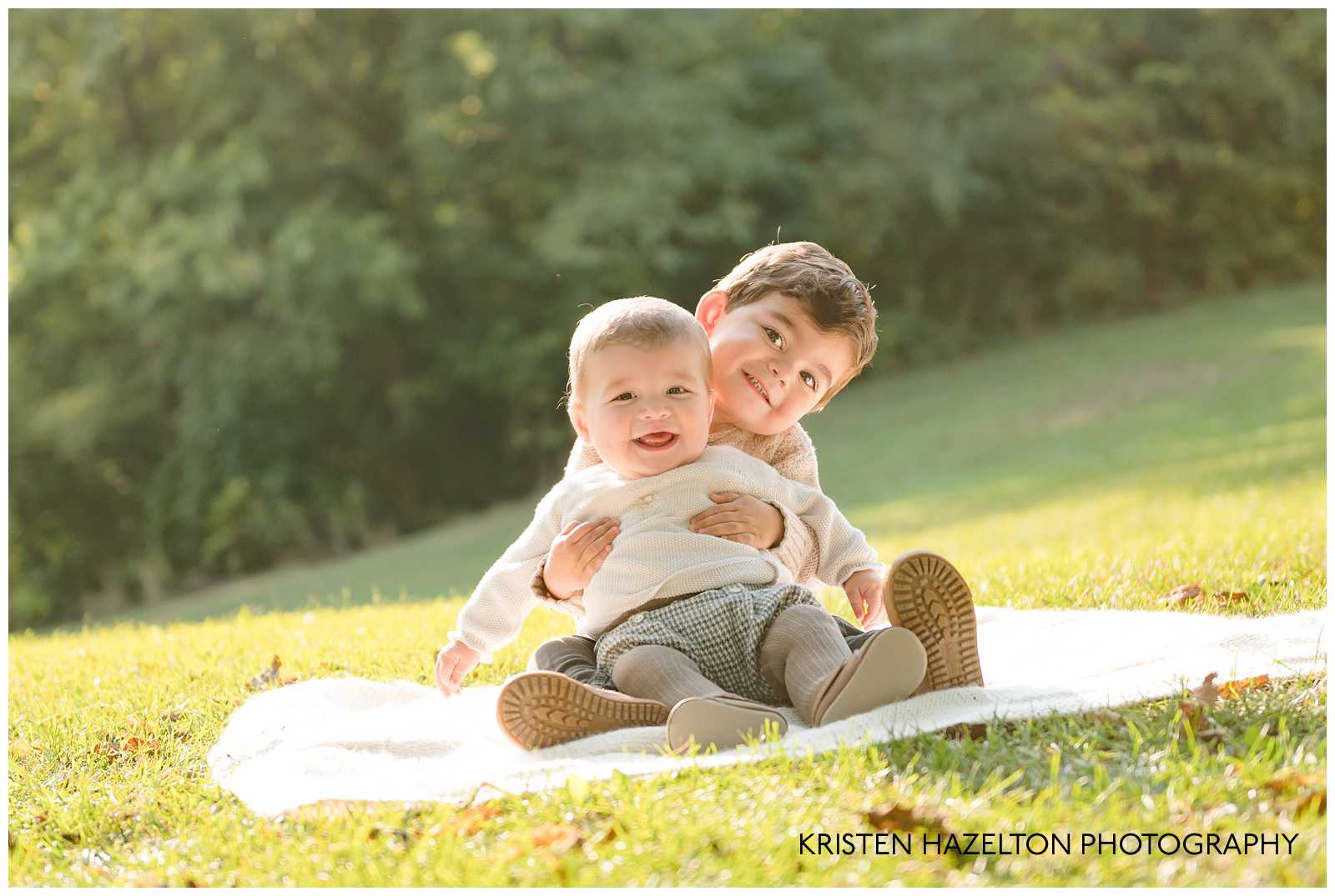 Big brother sitting and holding his baby brother by Riverside, IL photographer Kristen Hazelton