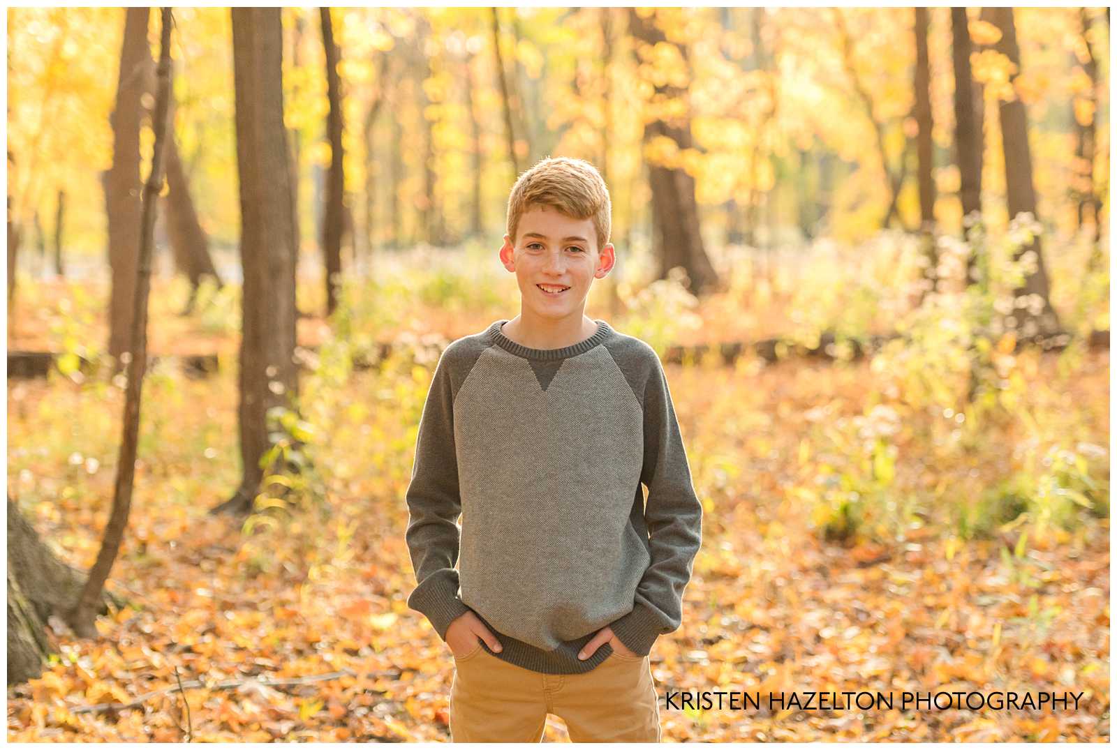 Cheerful teen boy in the fall woods at photographer Kristen Hazelton's River Forest IL Fall Mini Sessions