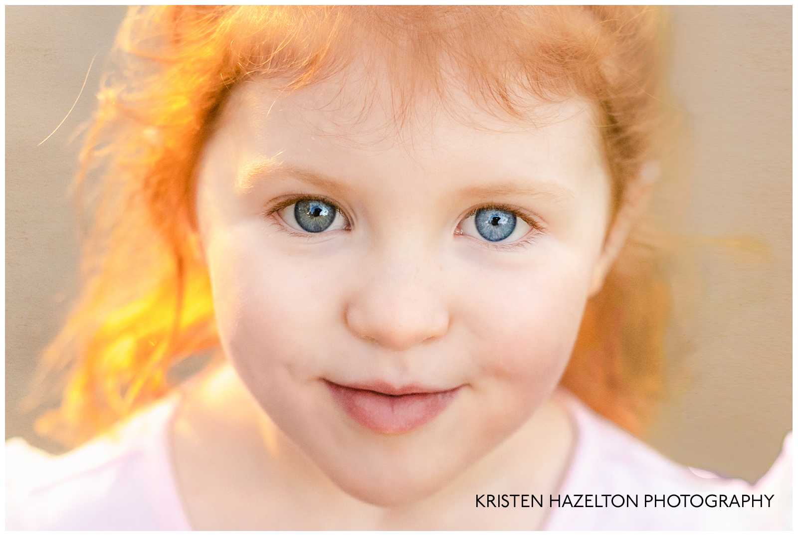 Closeup portrait of a red headed girl with heterochromia by photographer Kristen Hazelton
