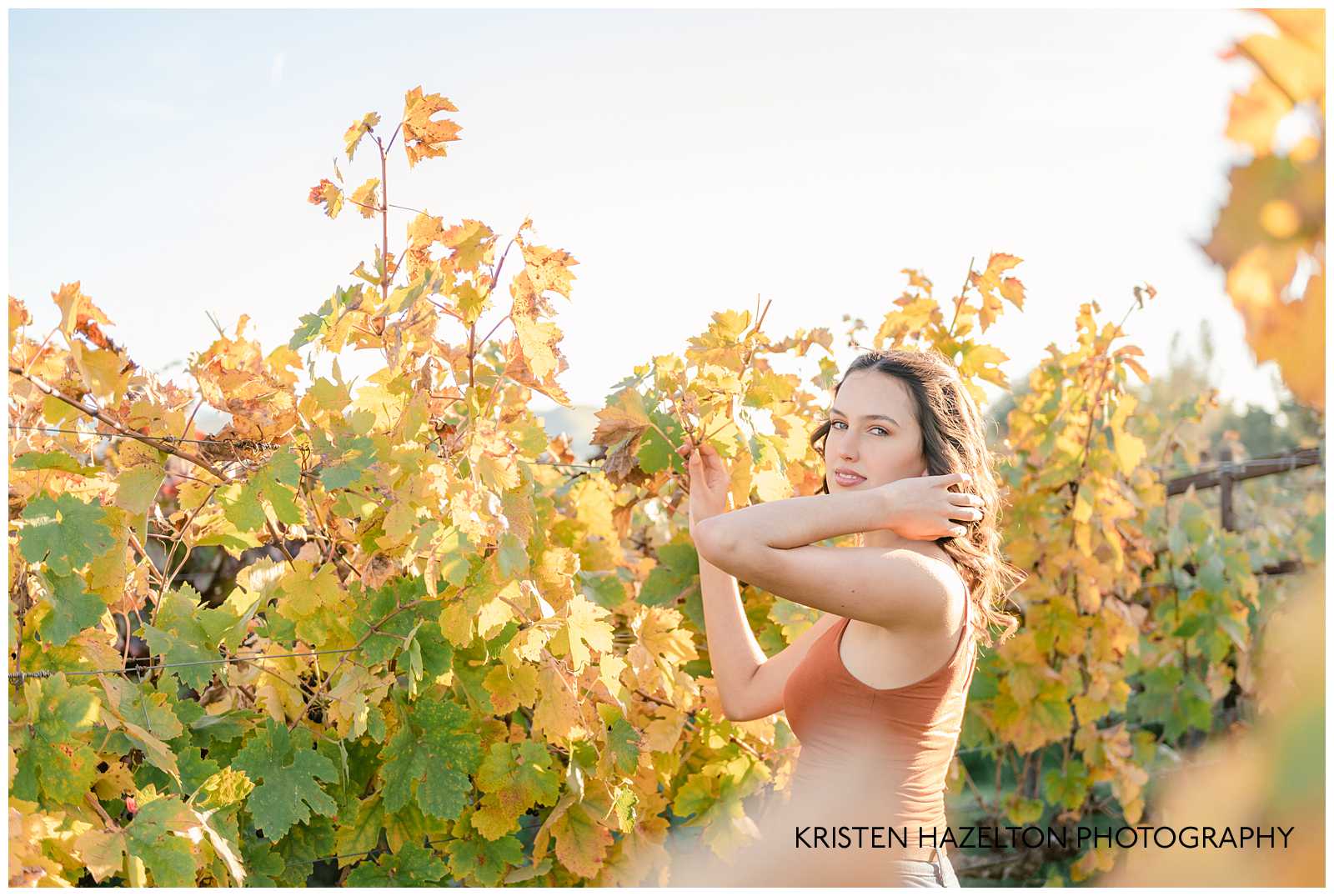 Girl wearing orange shirt in a vineyard