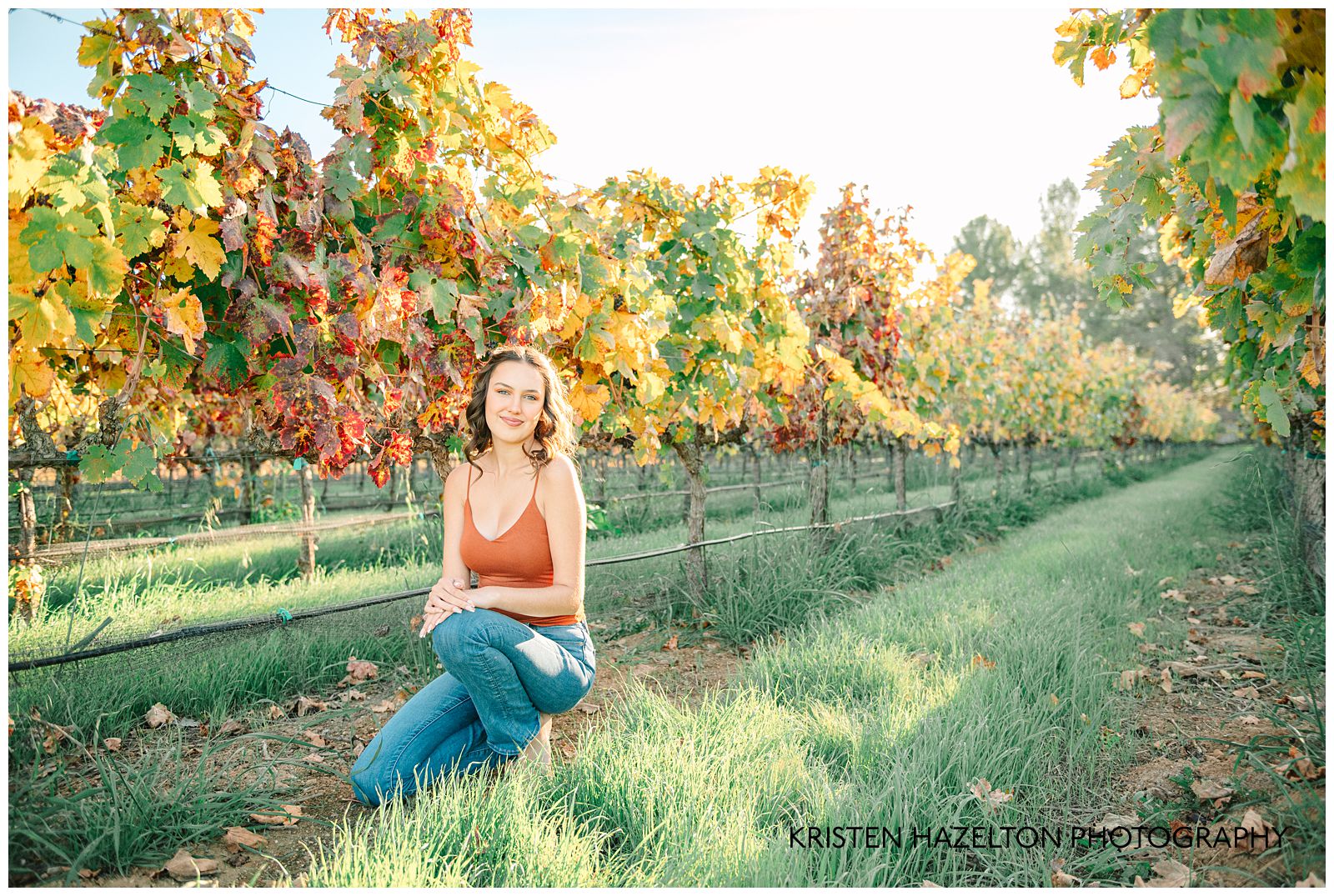 Ravenswood Livermore Photos: a girl in an orange tank top crouches in a vineyard in the fall