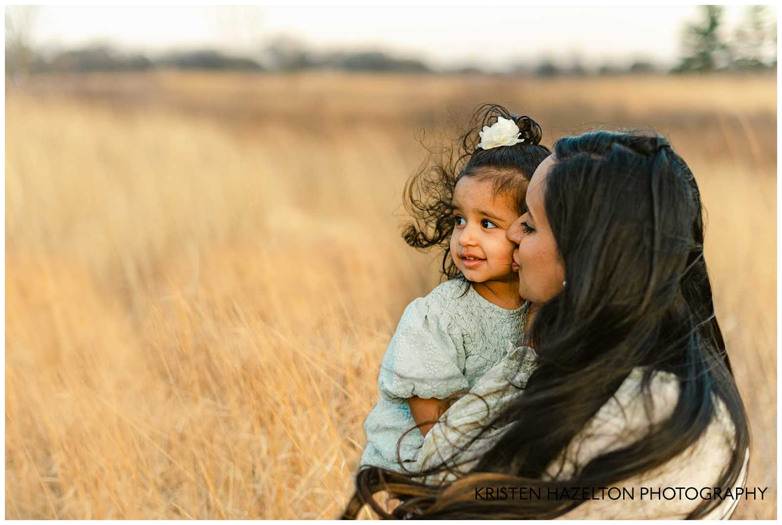 Mom giving daughter a kiss on the cheek; Hinsdale maternity photography by Kristen Hazelton