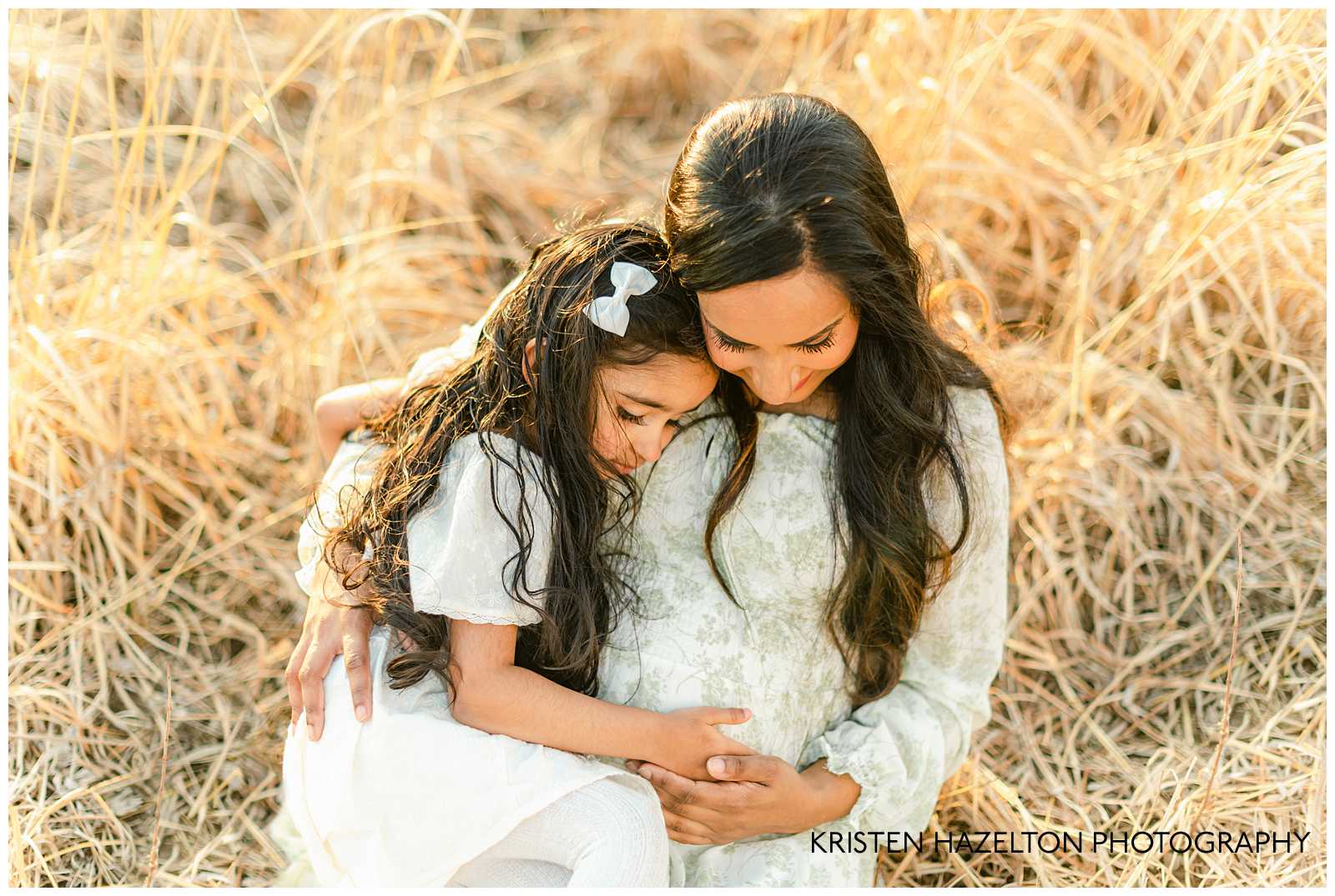 Mom and daughter holding baby bump; Hinsdale maternity photography by Kristen Hazelton