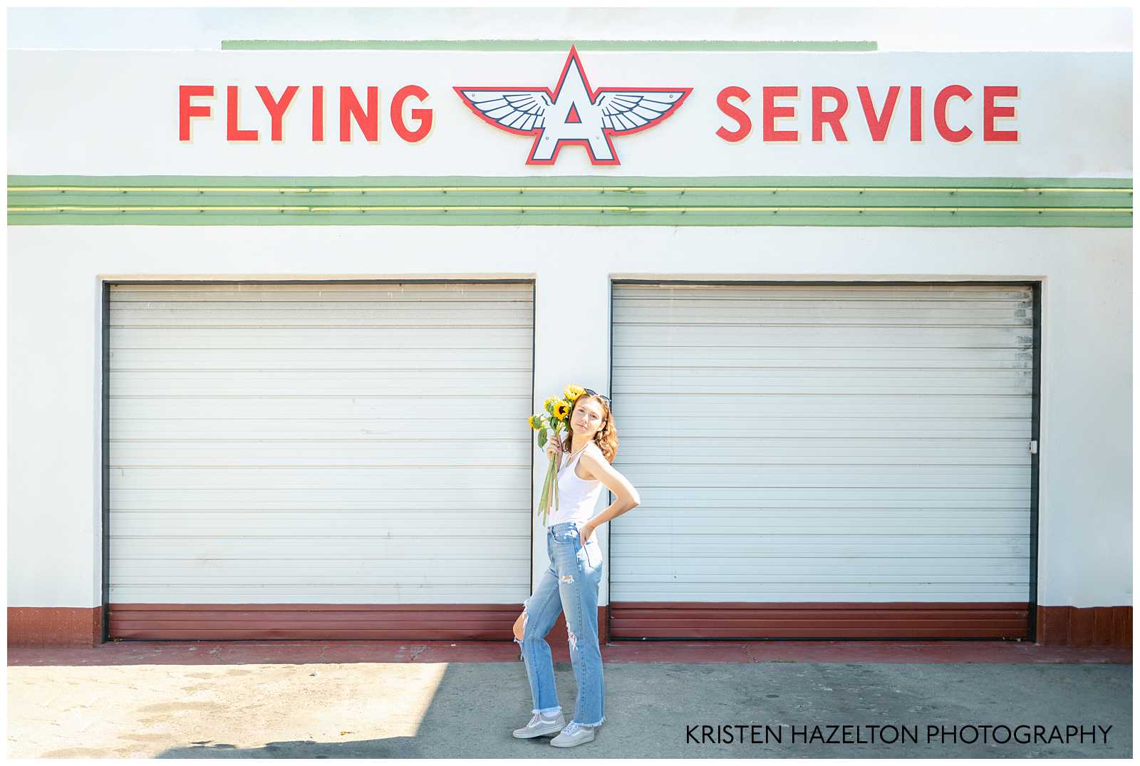 High school senior photos at a car mechanic garage that reads "Flying A Service" by San Jose, CA Senior Photographer Kristen Hazelton