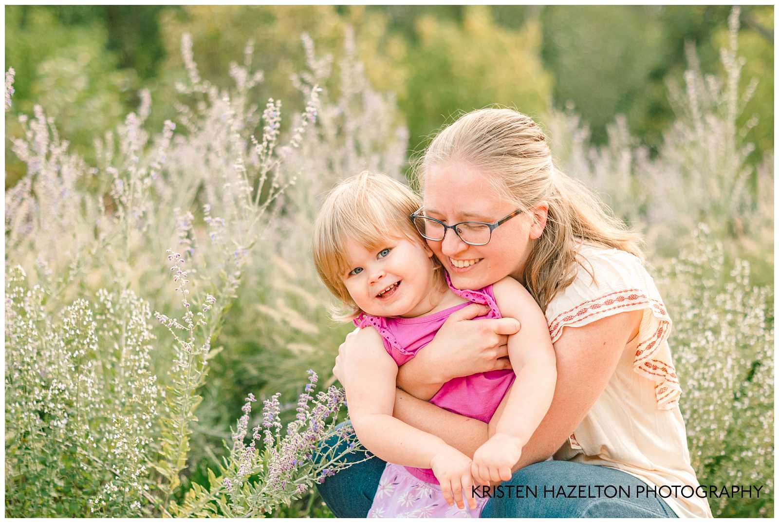 Mother wearing glasses hugging her toddler daughter. Cantigny Park photography by Kristen Hazelton