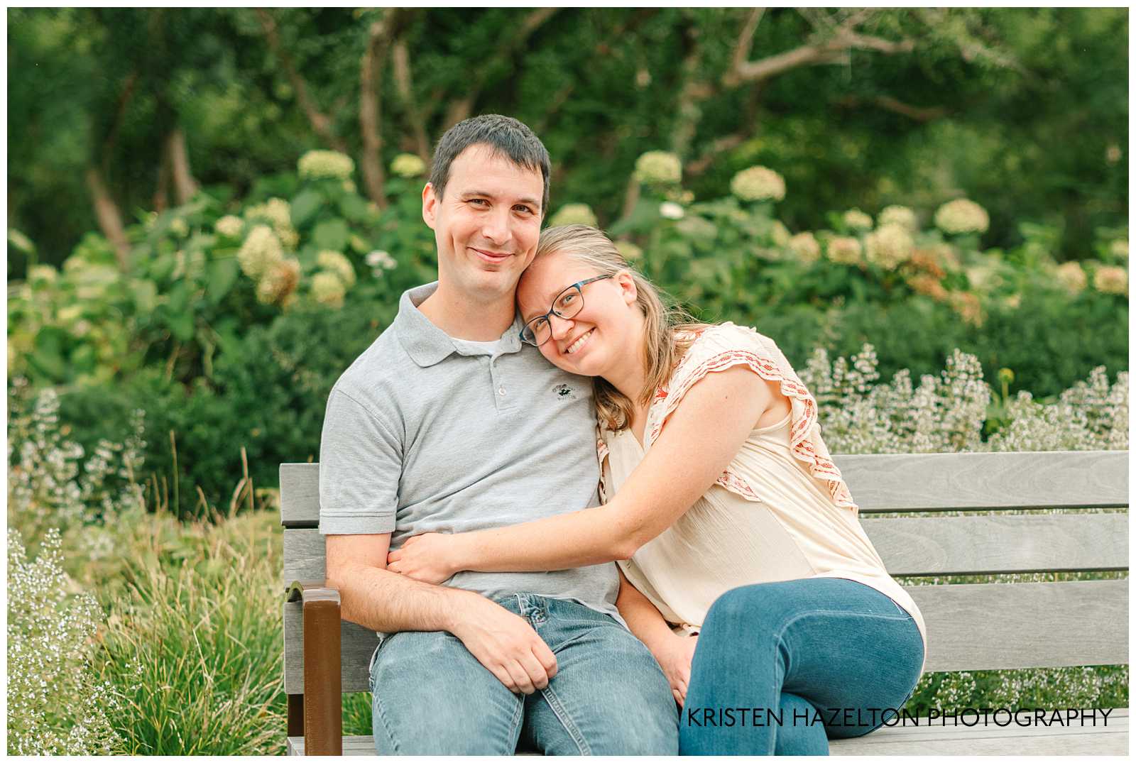Young couple hugging on a bench. Cantigny Park photography by Kristen Hazelton