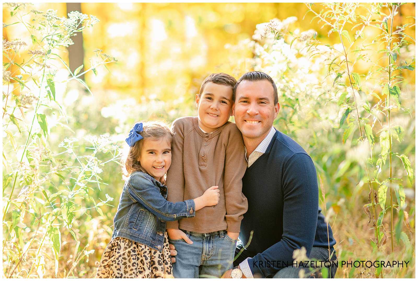 Dad and his young son and daughter surrounded by beautiful fall colors at their fall family photos in River Forest, IL.