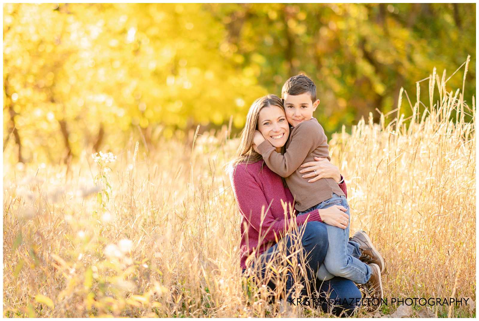 A little boy hugging his mom in tall yellow grass during their fall family photos in River Forest, IL.