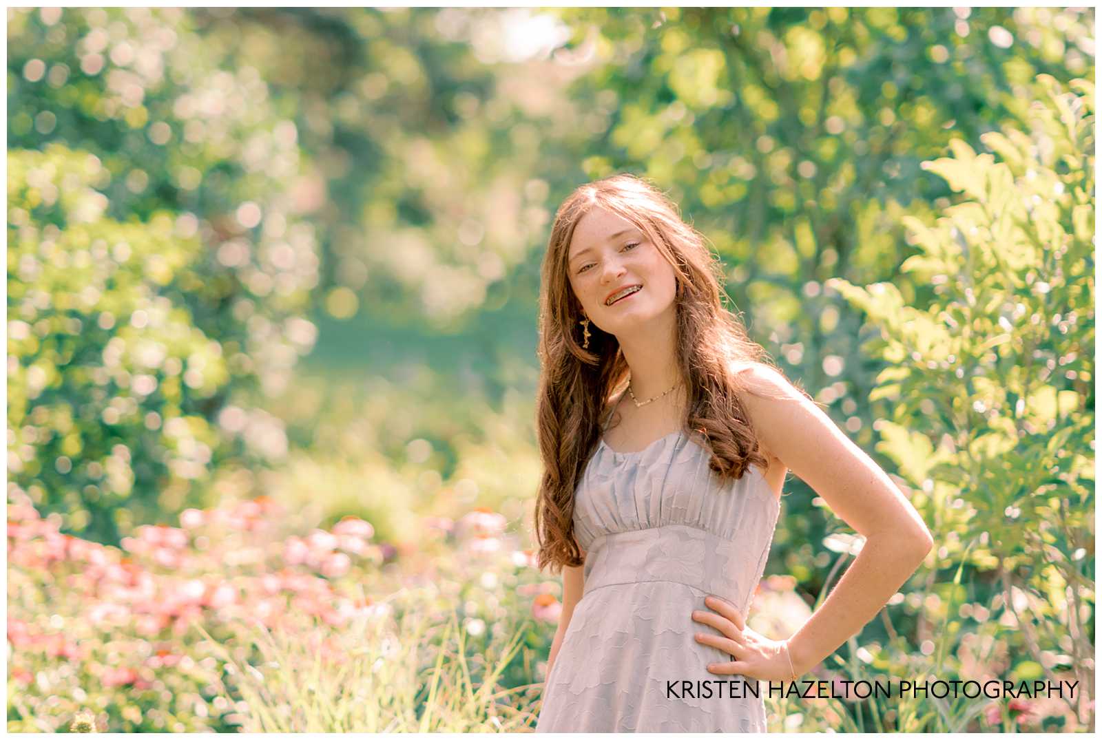 Summer Senior photos at Lilacia Park in Lombard IL; girl wearing a blue sundress in a garden of pink flowers