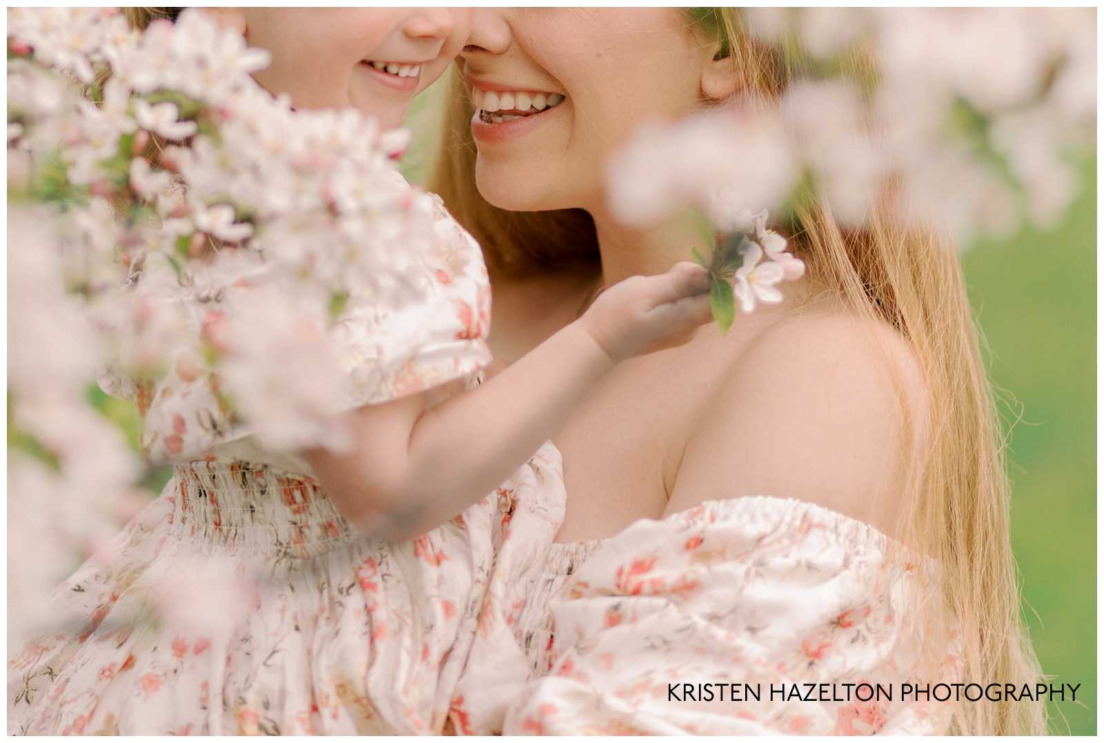 Mother and daughter smiling with white flowers during their St Patrick's Day in Chicago photoshoot