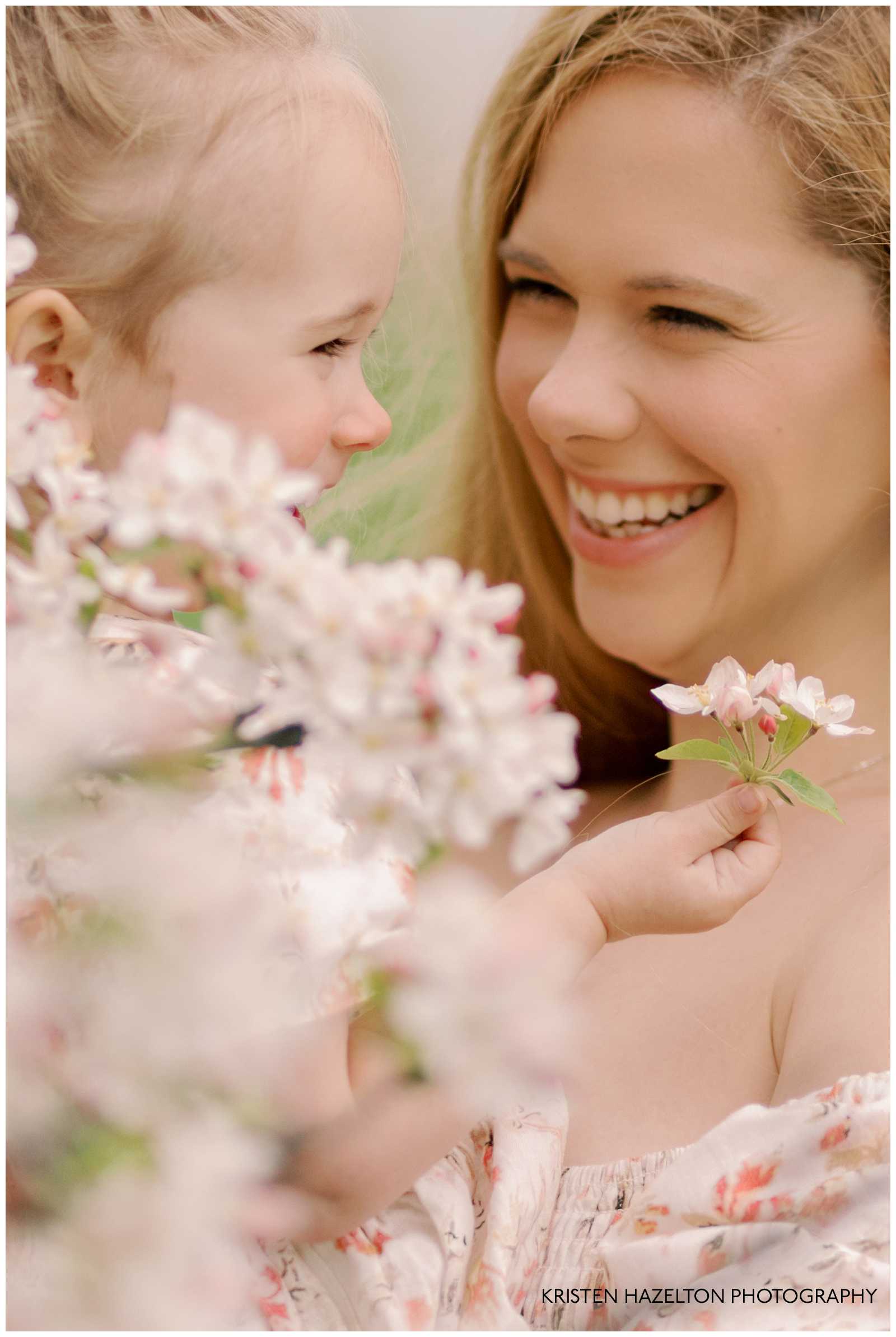 Mother and daughter smiling with white flowers during their St Patrick's Day in Chicago photoshoot