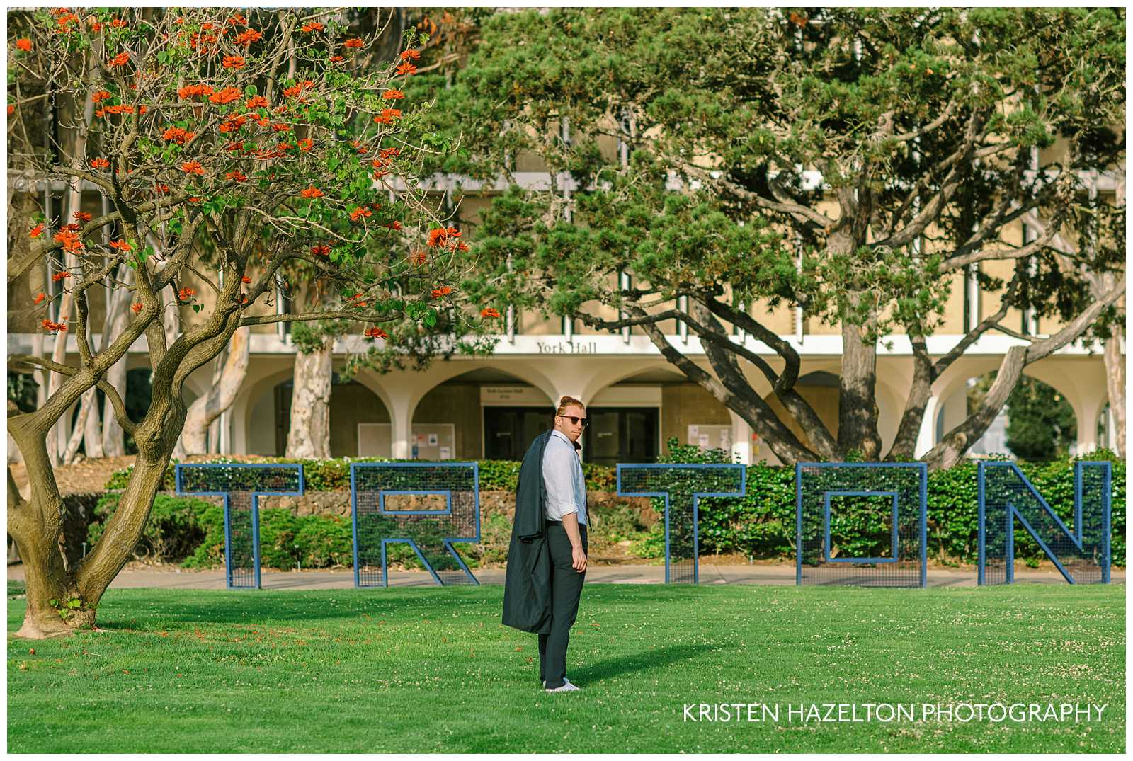 College graduate wearing sunglasses for his UC San Diego pictures for graduation by photographer Kristen Hazelton.