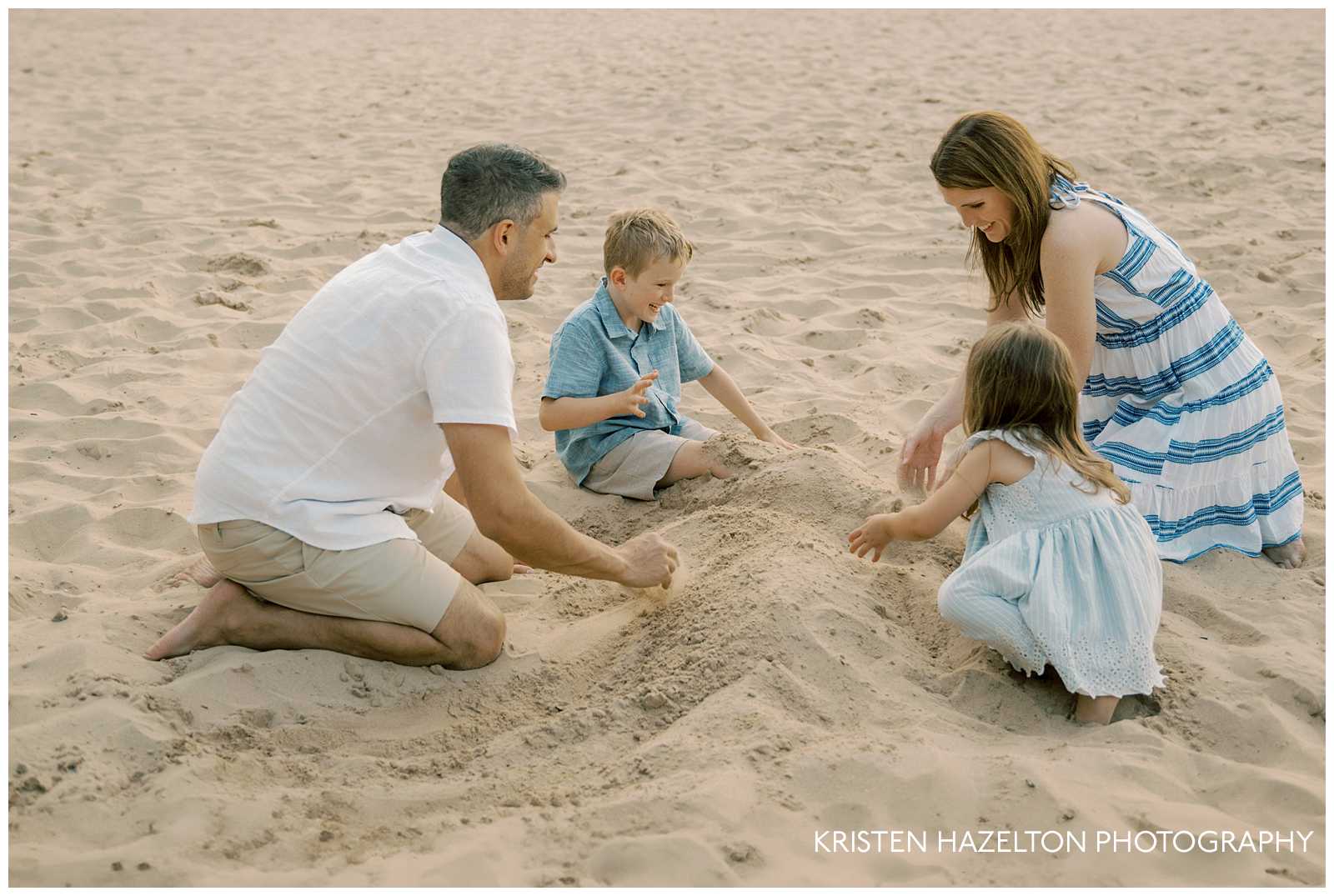 Family of four playing in the sand. Beach family photography by Chicago photographer Kristen Hazelton.