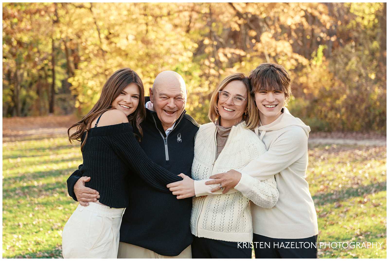 Teenage grandkids hugging their grandparents in their fall portraits by Evanston photographer Kristen Hazelton. 