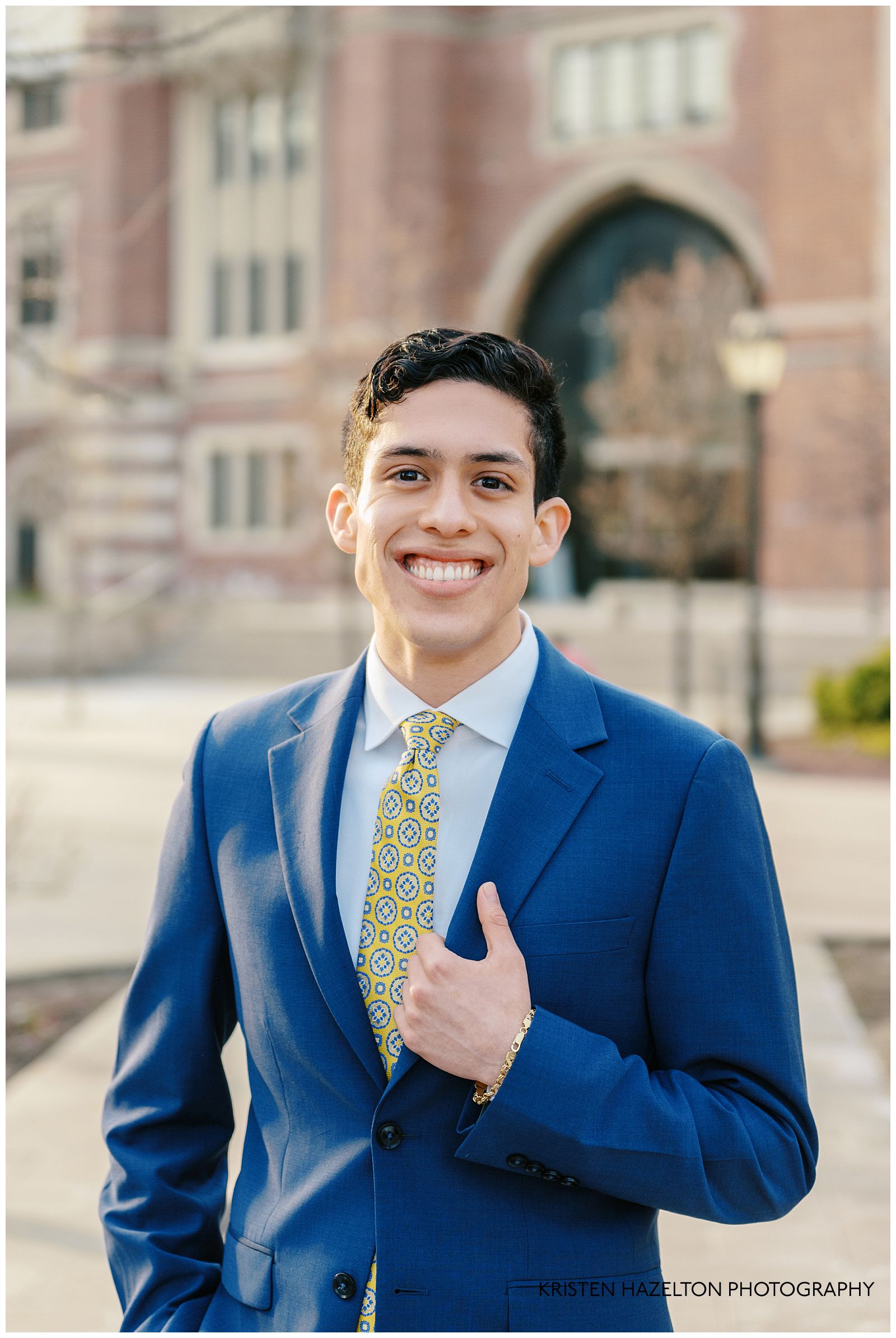 Main in blue suit with yellow patterned tie