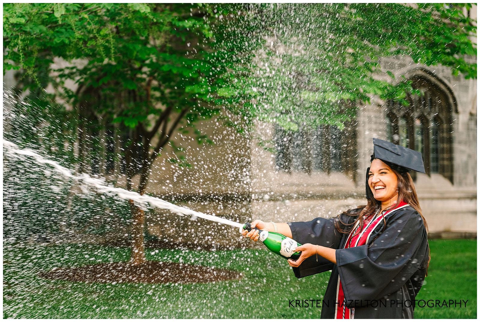 University graduate popping a bottle of champagne during a photoshoot and demonstrating the best champagne to pop: Cook's