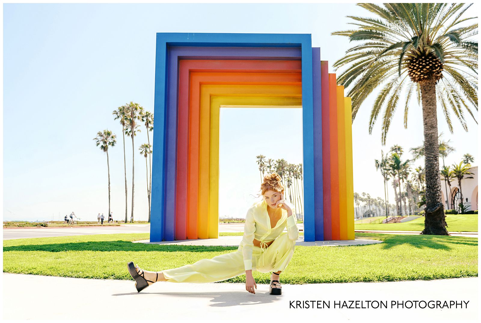 Redheaded model wearing a butter yellow linen outfit for her Chromatic gate photos along the Santa Barbara, CA beachfront