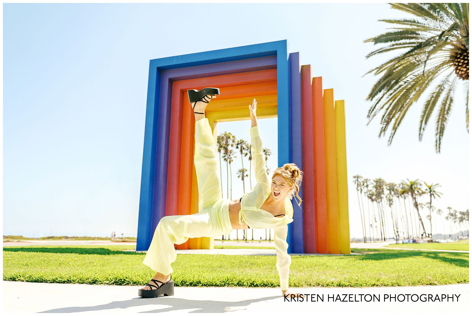 Redheaded model wearing a butter yellow linen outfit for her Chromatic gate photos along the Santa Barbara, CA beachfront