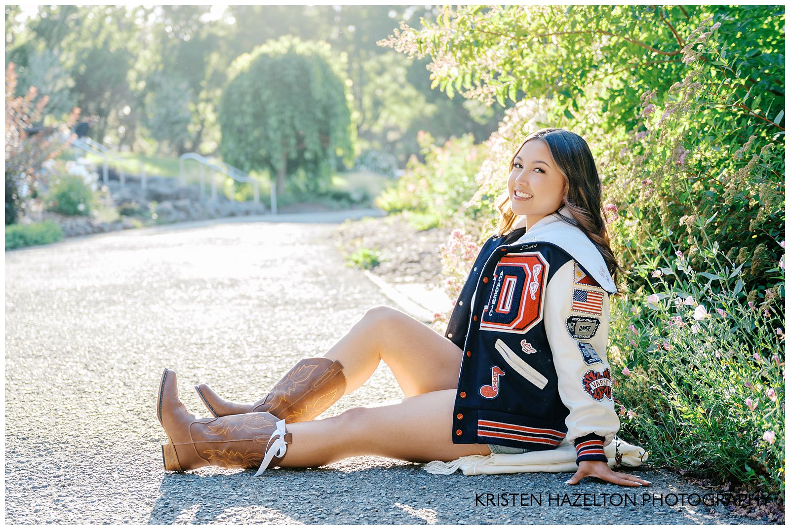 Girl wearing a varsity jacket seated in a native plant garden at the Gardens at Heather Farms in Walnut Creek