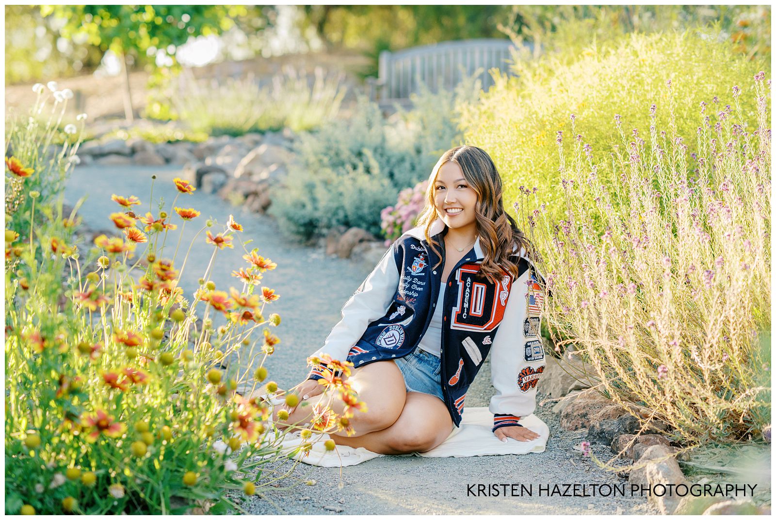 Girl wearing a varsity jacket seated in a native plant garden at the Gardens at Heather Farms in Walnut Creek